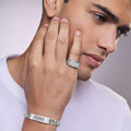 Man wearing Anthem collection Caviar beaded sterling silver ring with pavé diamonds, 12 mm band