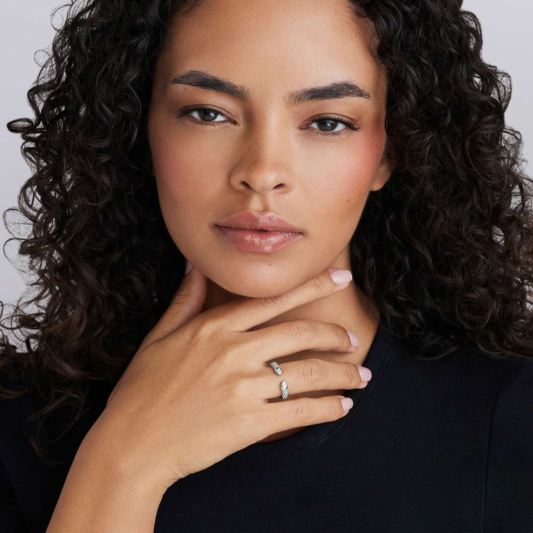 Young woman showcasing the Signature Caviar Sterling Silver Diamond Mini Versa Stacking Ring with Caviar beading and Pavé diamonds.