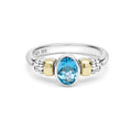 Signature Caviar Two-Tone Swiss Blue Topaz Oval Ring in sterling silver with 14K gold accents, featuring a pear-cut blue topaz and caviar beading.