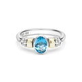Signature Caviar Two-Tone Swiss Blue Topaz Oval Ring in sterling silver with 14K gold accents, featuring caviar beading and an oval-cut blue gemstone centerpiece.