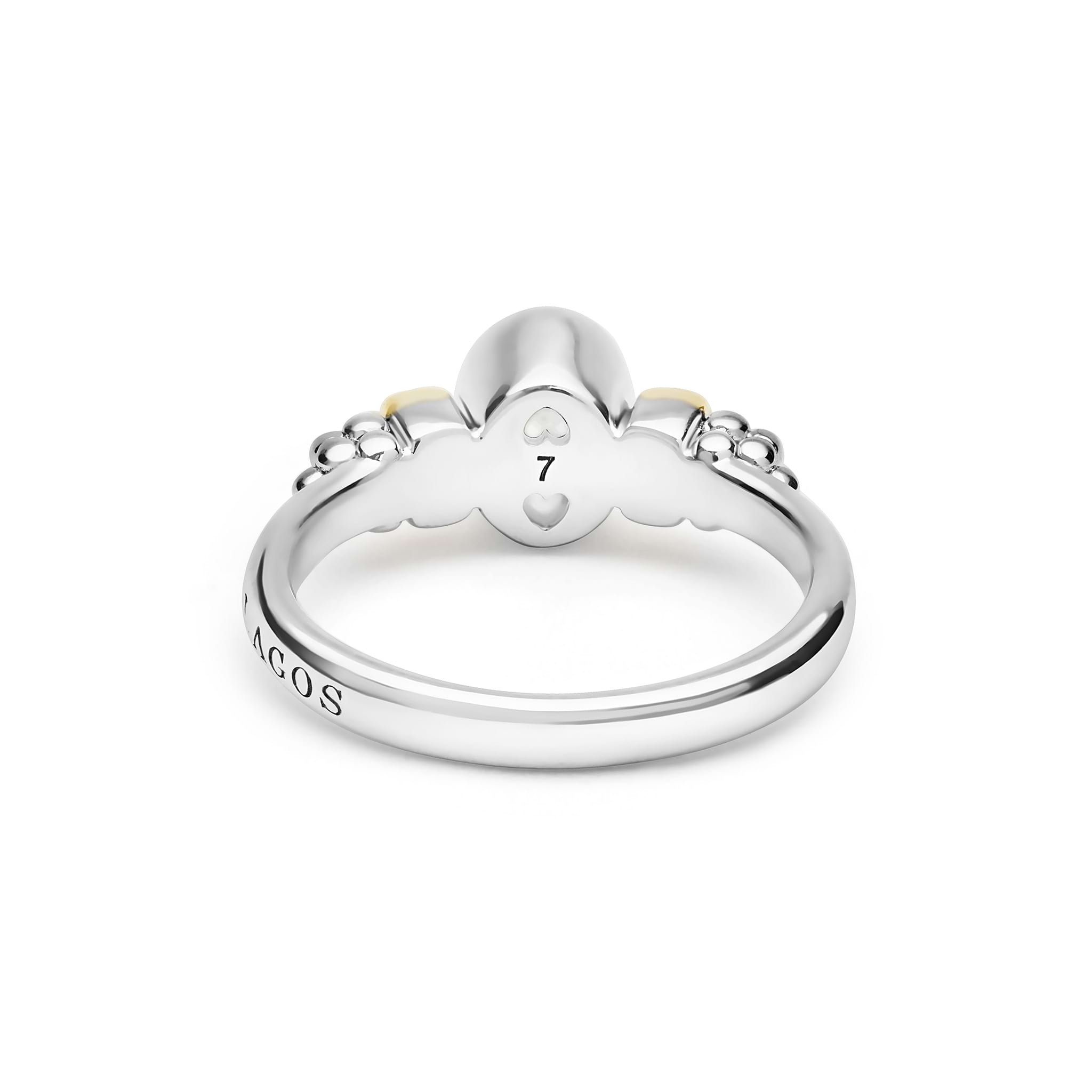 Signature Caviar Two-Tone White Topaz Oval Ring in sterling silver with heart motifs, maker’s mark visible, featuring caviar beading and polished 14K gold details.