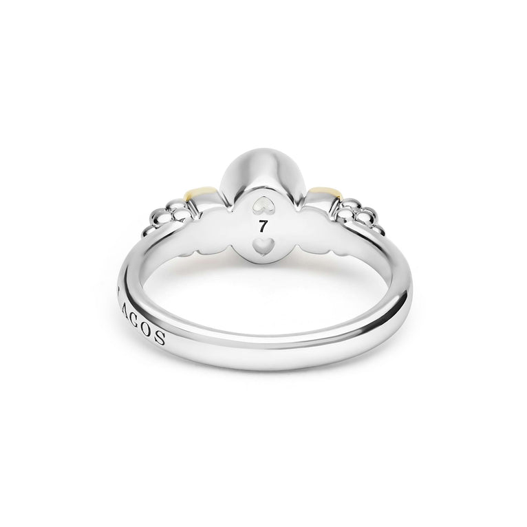 Signature Caviar Two-Tone White Topaz Oval Ring in sterling silver with heart motifs, maker’s mark visible, featuring caviar beading and polished 14K gold details.