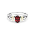Signature Caviar Two-Tone Garnet Oval Ring featuring a central red garnet, sterling silver band, and 14K gold accents with caviar beading.