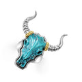 Intricately crafted turquoise gemstone and 18K gold bull motif ring surrounded by sterling silver.