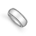 Smooth sterling silver and Caviar beading form this classic band ring.