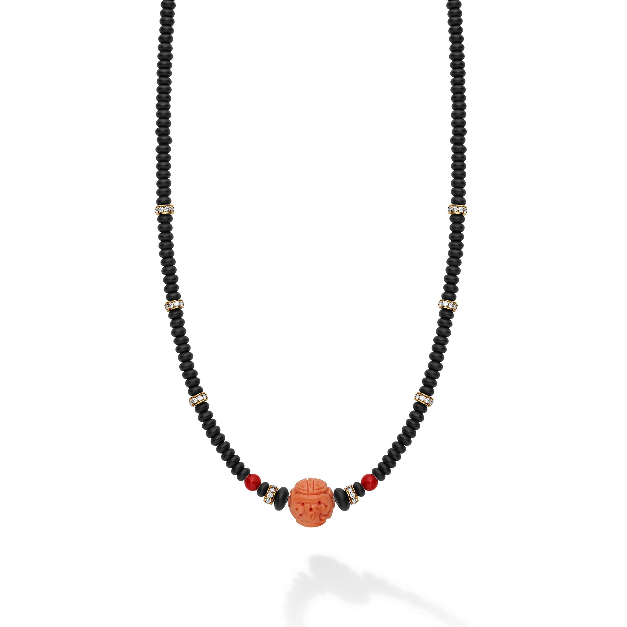 Featuring vibrant pink and red hand carved coral beads set against matte black onyx, delicate diamond accents add a touch of sparkle, making this piece perfect for any occasion.