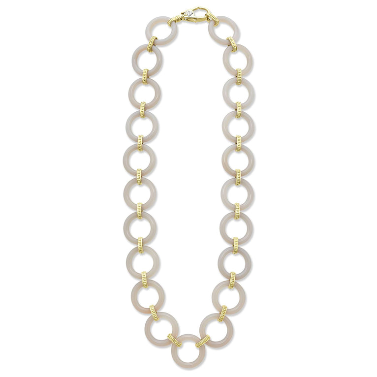 A classic necklace with 18K gold and ceramic circle details.
