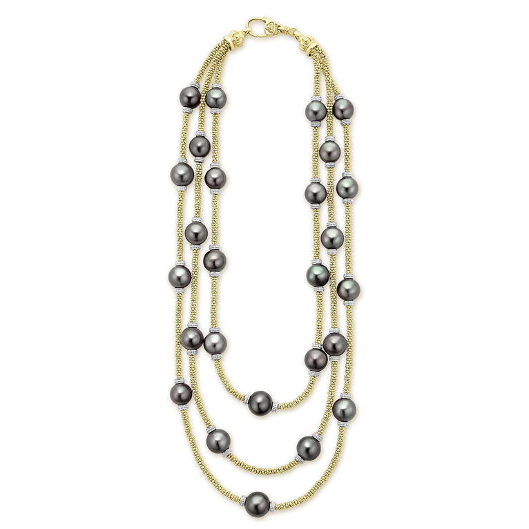 Tahitian black pearl stations highlighted on a 18K gold beaded necklace.