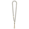 This tassel link necklace features black ceramic hoops linked together by 18K gold, cascading down to a tassel of 18K Caviar Gold.