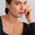 Woman wearing Caviar Gold Caviar Tassel Diamond Pendant Necklace with 18K gold and diamond accents, featuring a tassel detail.