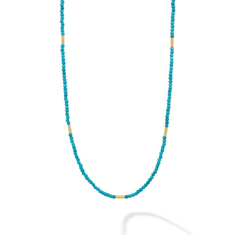 Seven 18K gold stations surrounded by Turquoise gemstone Caviar beading forms this strand necklace.