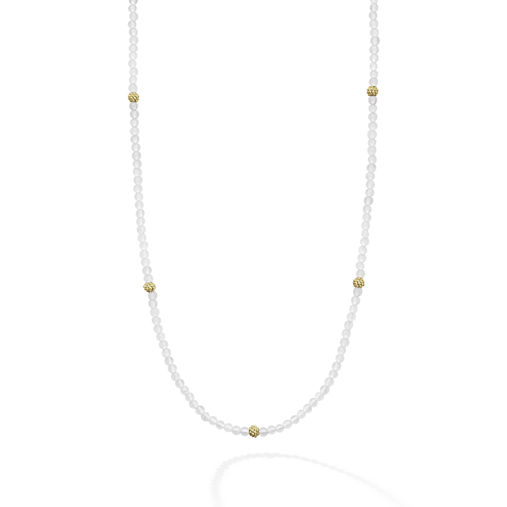 Seven 18K gold stations surrounded by Rose Quartz Caviar beading forms this strand necklace.