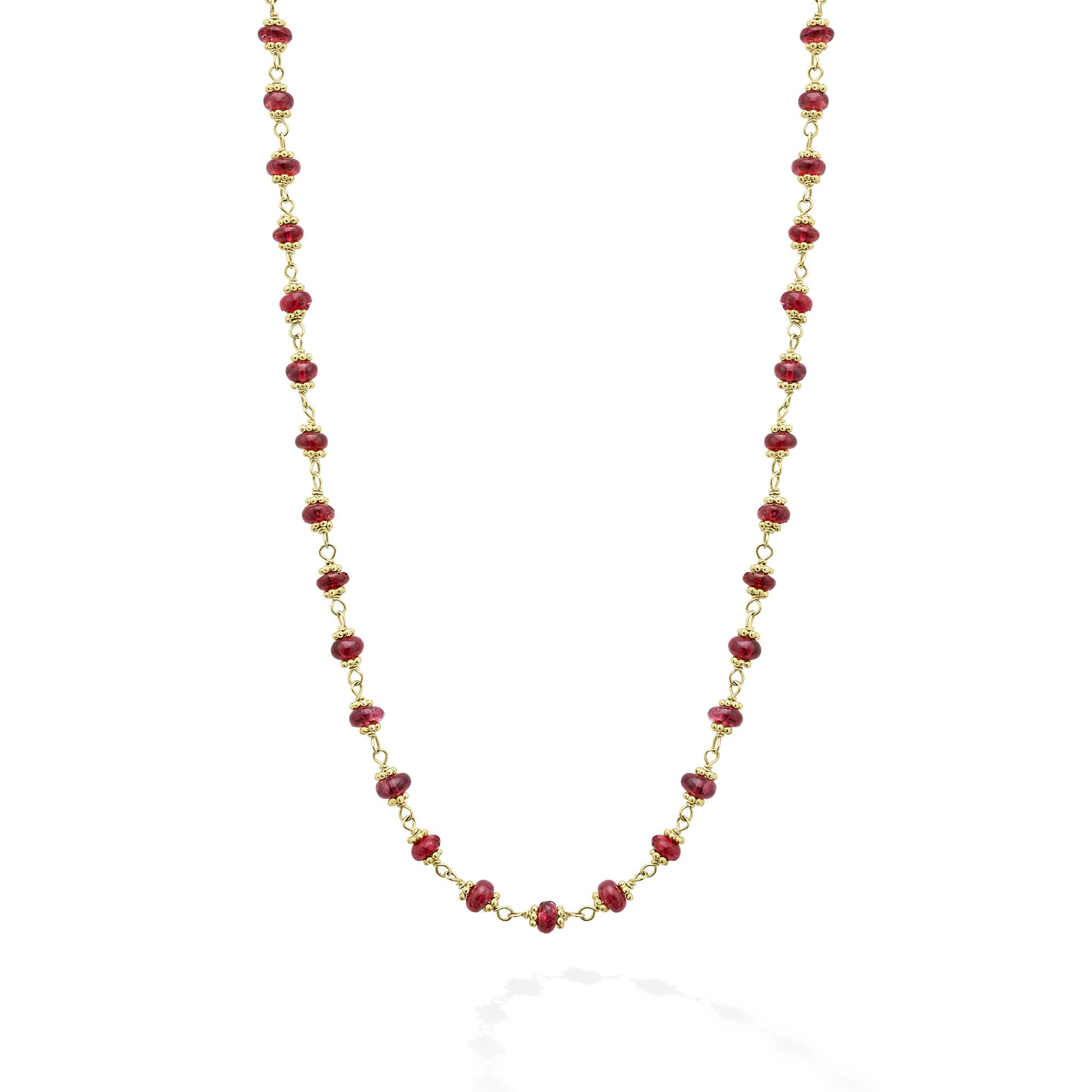 18k gold and ruby gemstone stations form this necklace.