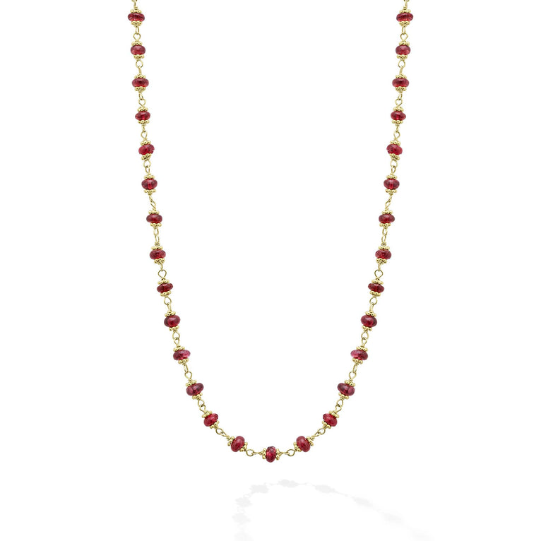 18k gold and ruby gemstone stations form this necklace.