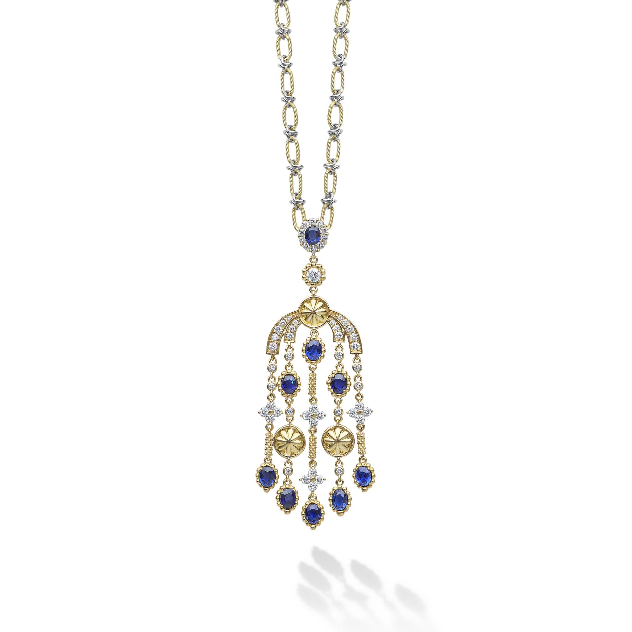 Featuring nine oval facet-cut blue sapphires, this stunning piece captures the brilliance and depth of gemstones. Each sapphire is accented by radiant diamonds, creating a mesmerizing cascade of color and sparkle.