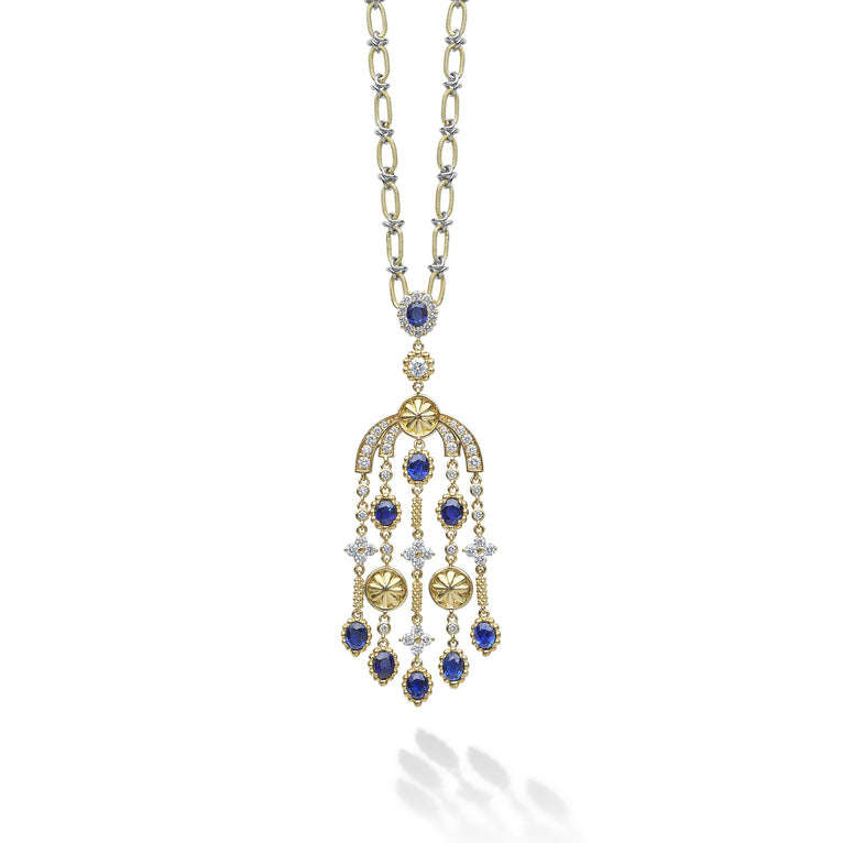Featuring nine oval facet-cut blue sapphires, this stunning piece captures the brilliance and depth of gemstones. Each sapphire is accented by radiant diamonds, creating a mesmerizing cascade of color and sparkle.