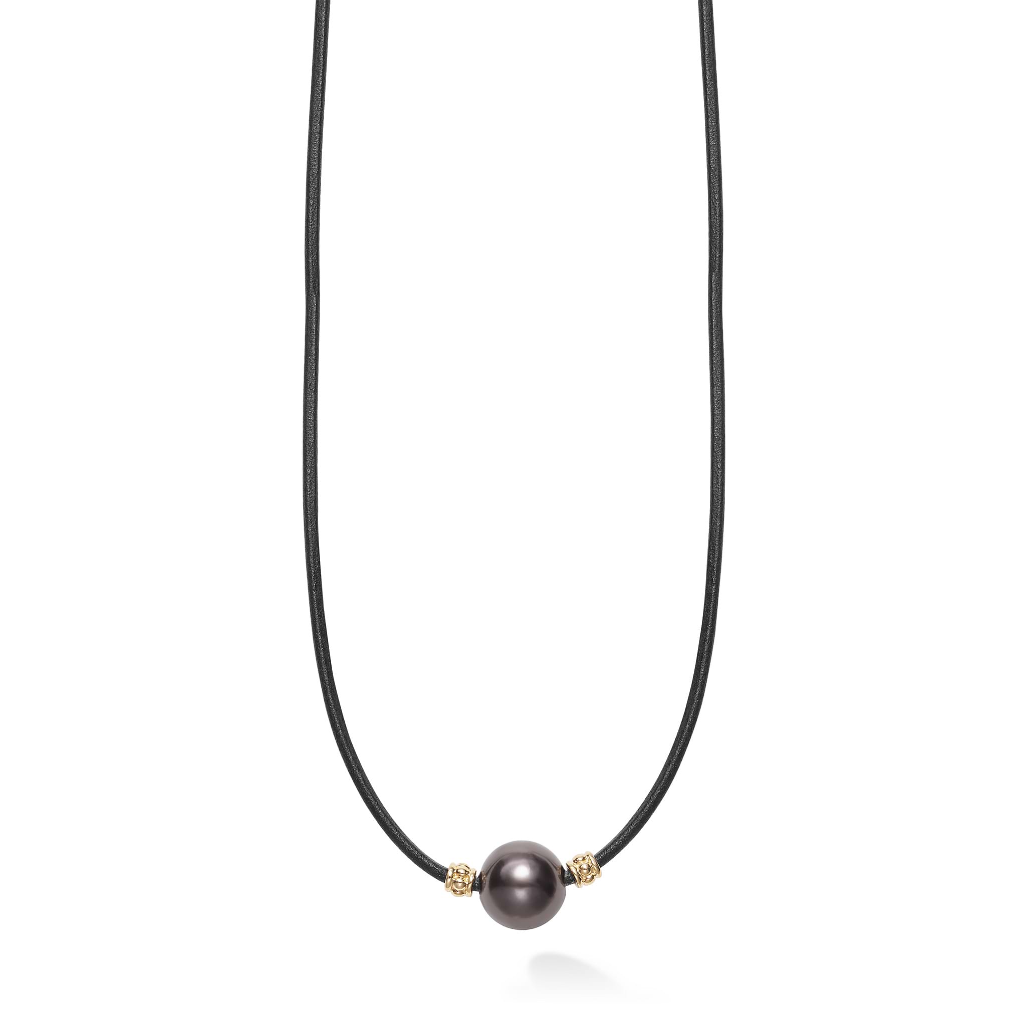 A single tahitian black pearl station accented by 18K gold finished on a 20 inch cord necklace.