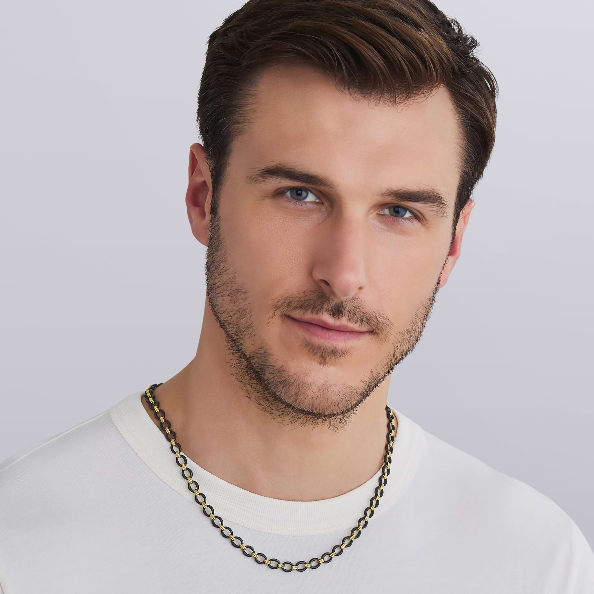man wearing 18K gold matte black ceramic oval link necklace with Caviar beaded links and lobster clasp, 7 mm width, 20–24 inch