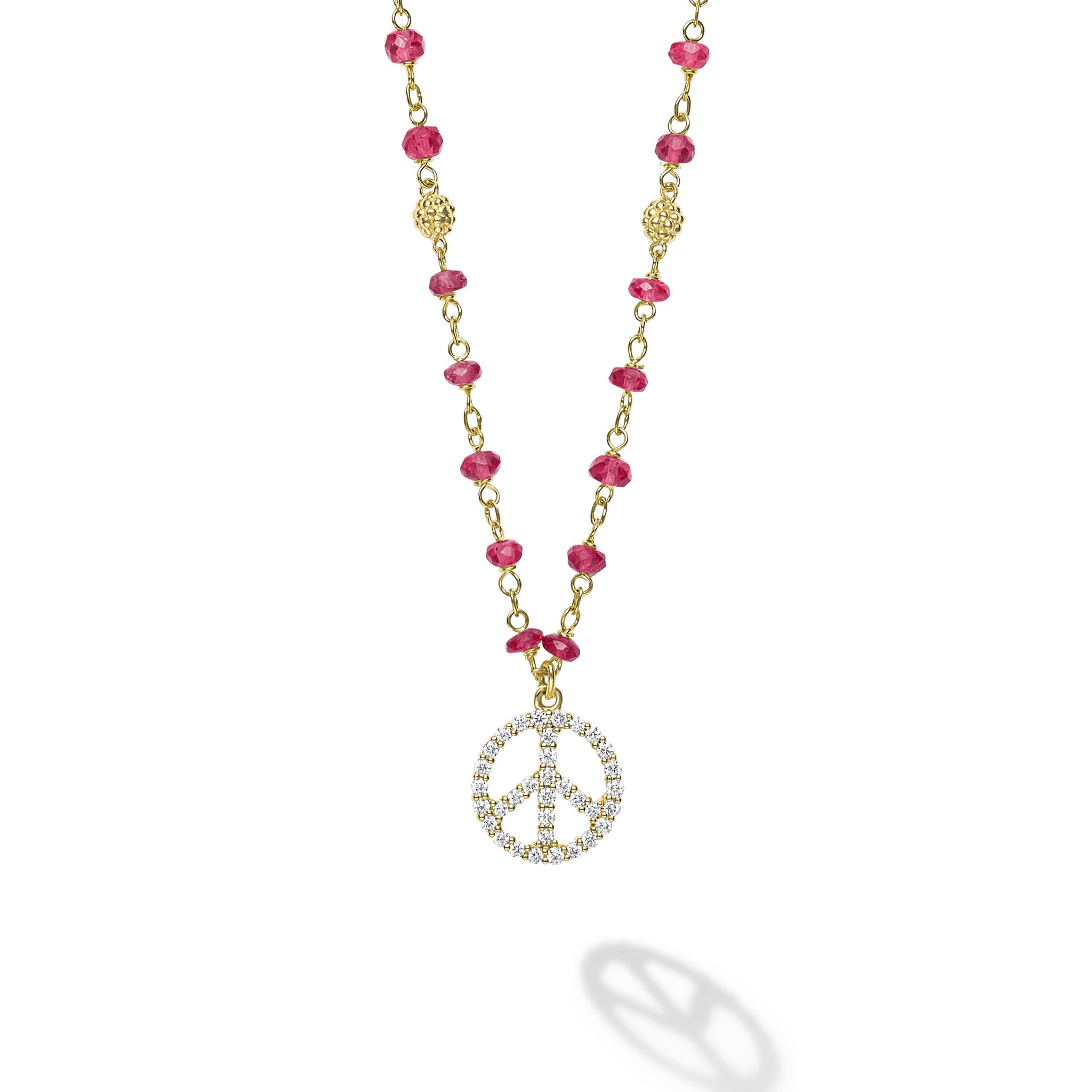 18k gold and ruby gemstones accented with round diamonds in a peace sign motif form this pendant necklace. LAGOS diamonds are the highest quality natural stones.
