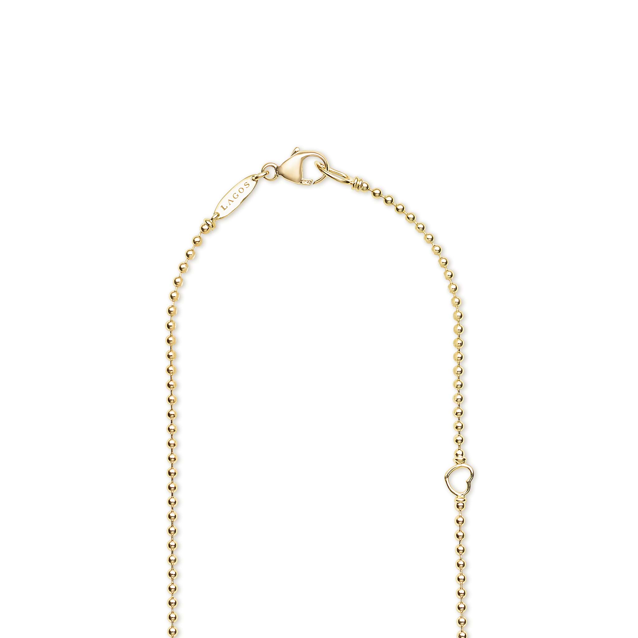 Gold beaded necklace with a lobster clasp on a white background with LAGOS engraving