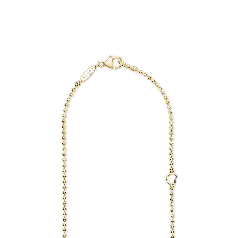 Gold beaded necklace with a lobster clasp on a white background with LAGOS engraving