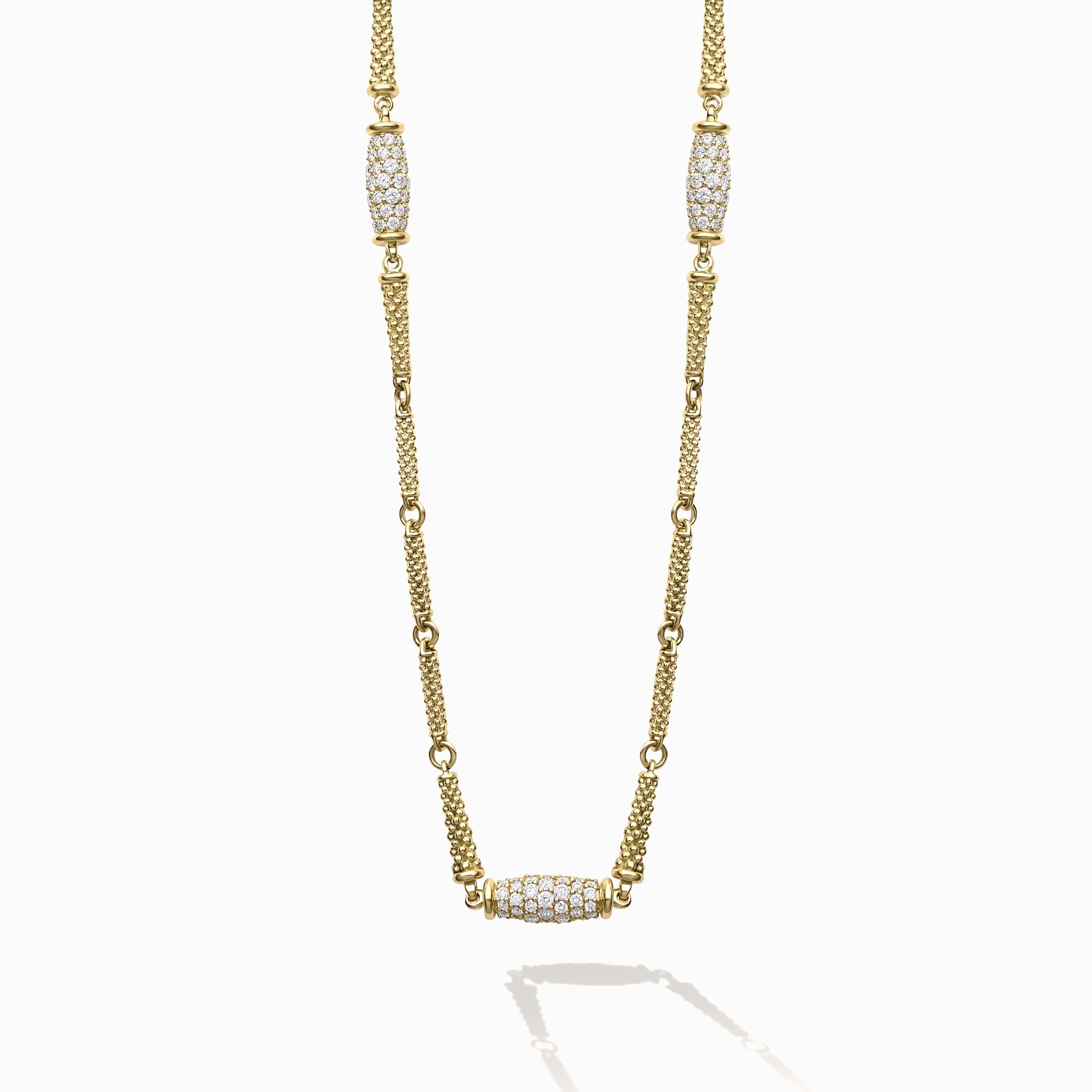 This 18K Caviar Gold Necklace features three barrel stations, adorned in brilliant diamonds.