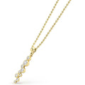 Zoom in of nine bezel-cut diamond pendant on a 18K gold beaded chain with white background
