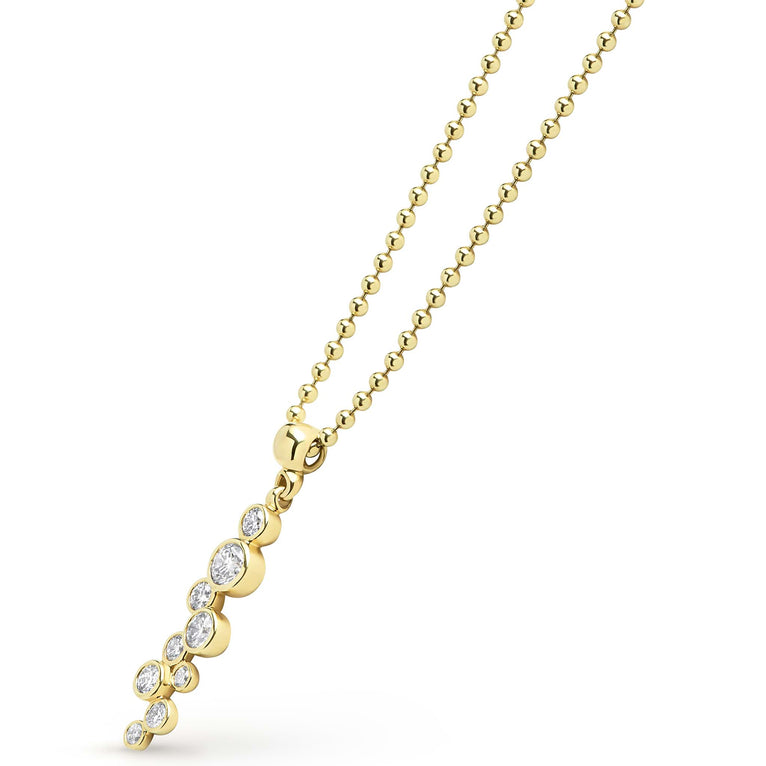 Zoom in of nine bezel-cut diamond pendant on a 18K gold beaded chain with white background