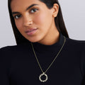 woman with black shirt wearing LAGOS 18K gold necklace with a circular diamond pendant