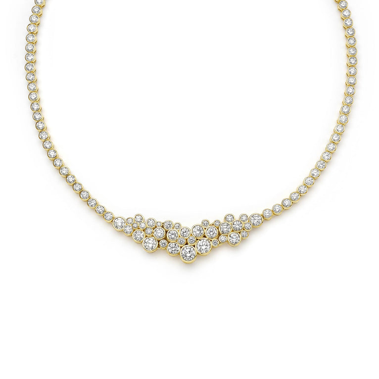 Gold necklace with clear stones on a white background