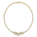 Gold necklace with diamond accents on a white background