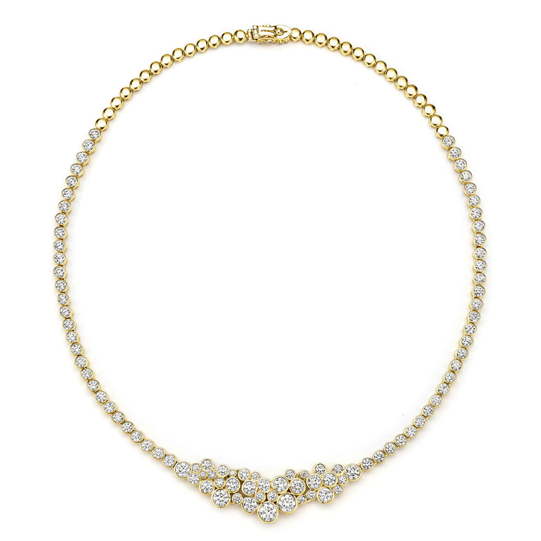 Gold necklace with diamond accents on a white background