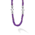 Purple beaded necklace with silver clasp on a white background