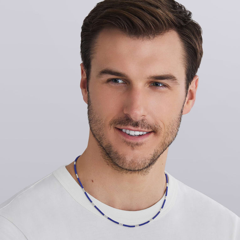 Man wearing LAGOS Silver Station Matte Blue Caviar beaded ceramic necklace with sterling silver lobster clasp, ultramarine