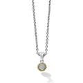 A diamond circle pendant set in sterling silver with 18K gold Caviar detailing on a chain necklace. LAGOS diamonds are the highest quality natural stones.