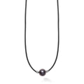 A single tahitian black pearl station accented by sterling silver finished on a 20 inch cord necklace.