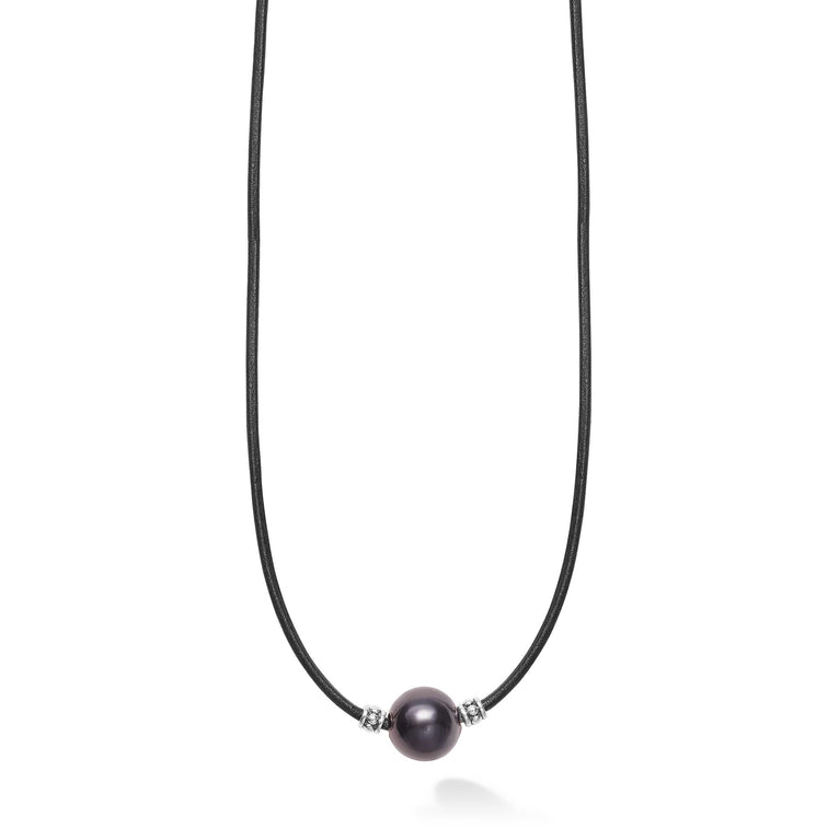 A single tahitian black pearl station accented by sterling silver finished on a 20 inch cord necklace.