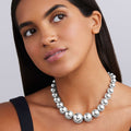 woman wearing bold sterling silver necklace beads grow from small to extra-large