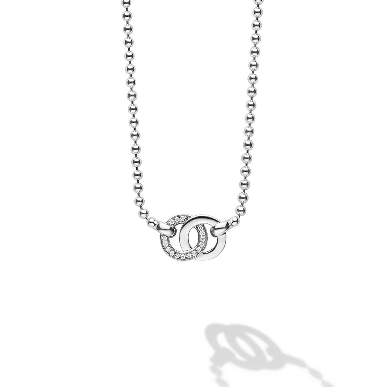 Signature Caviar Silver Interlocking Diamond Pendant Necklace, featuring a sterling silver ball chain and two interlocking rings, one adorned with tiny shimmering diamonds.