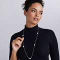 Woman wearing sterling silver necklace with large silver beading spaces on the chain