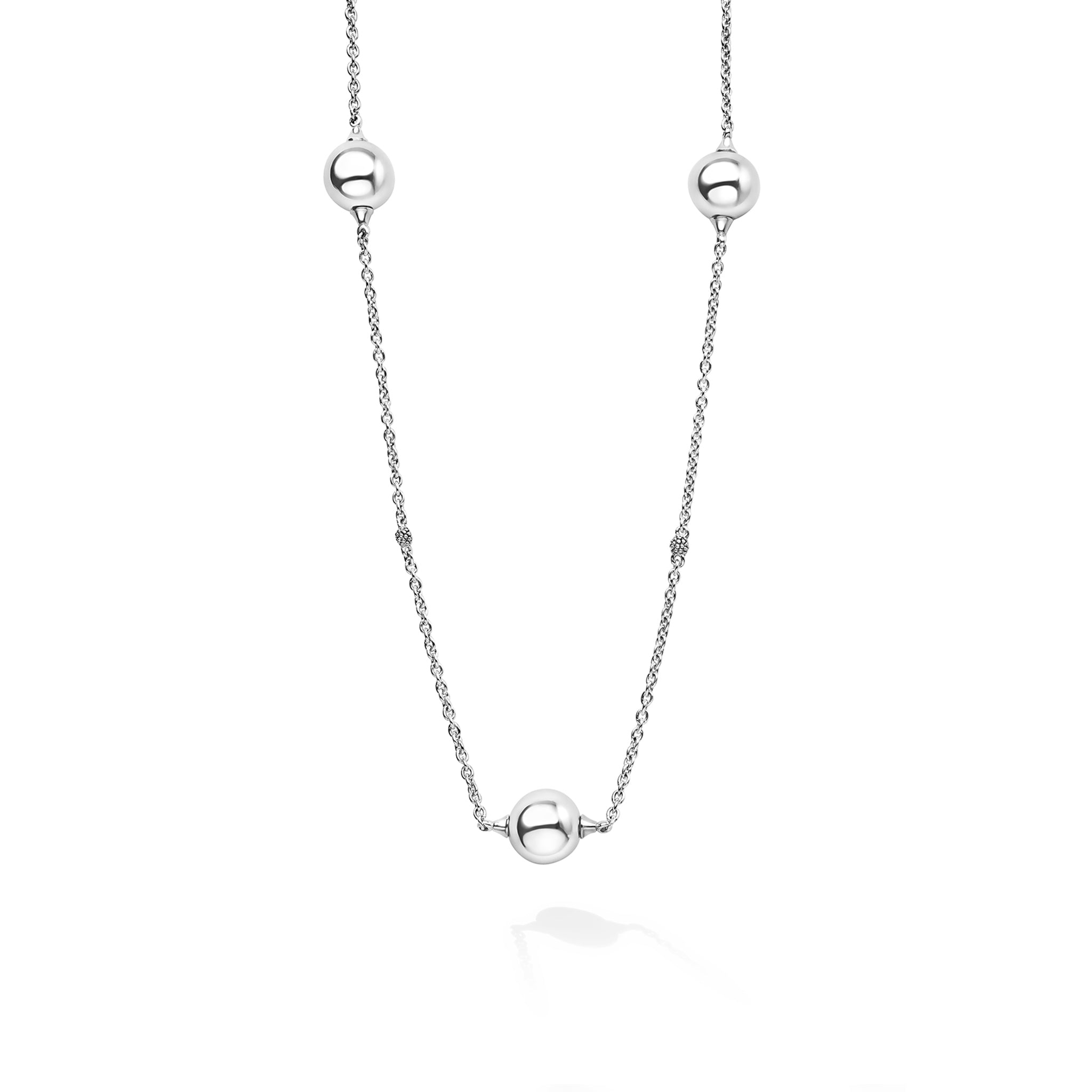 Silver necklace with three spherical beads on a white background