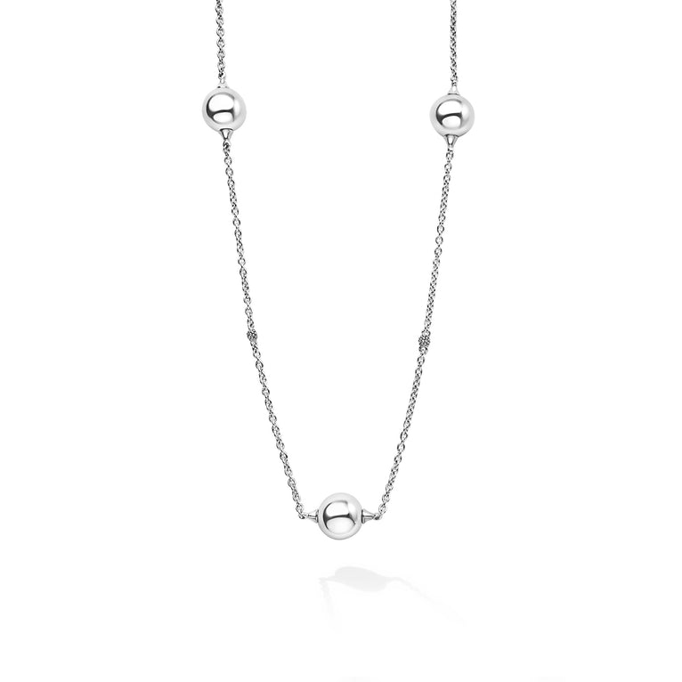 Silver necklace with three spherical beads on a white background