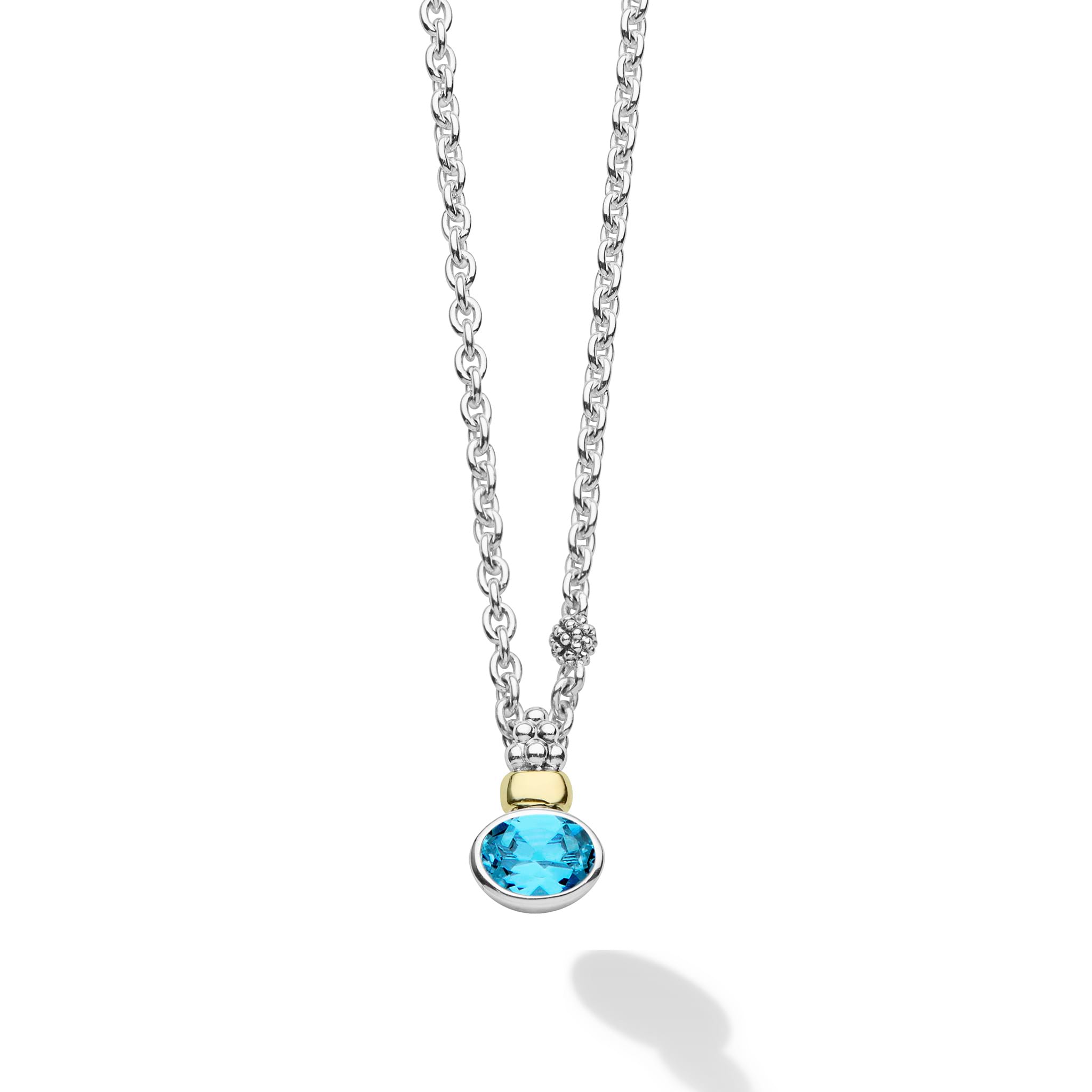 Signature Caviar Two-Tone Swiss Blue Topaz Oval Pendant Necklace features a vibrant blue topaz in sterling silver, accented with 14K gold, showcasing LAGOS elegance and craftsmanship.