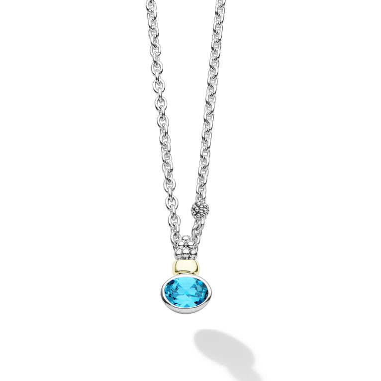 Signature Caviar Two-Tone Swiss Blue Topaz Oval Pendant Necklace with a facet-cut Swiss blue topaz gemstone, sterling silver accents, 14K gold detailing, and caviar beading.