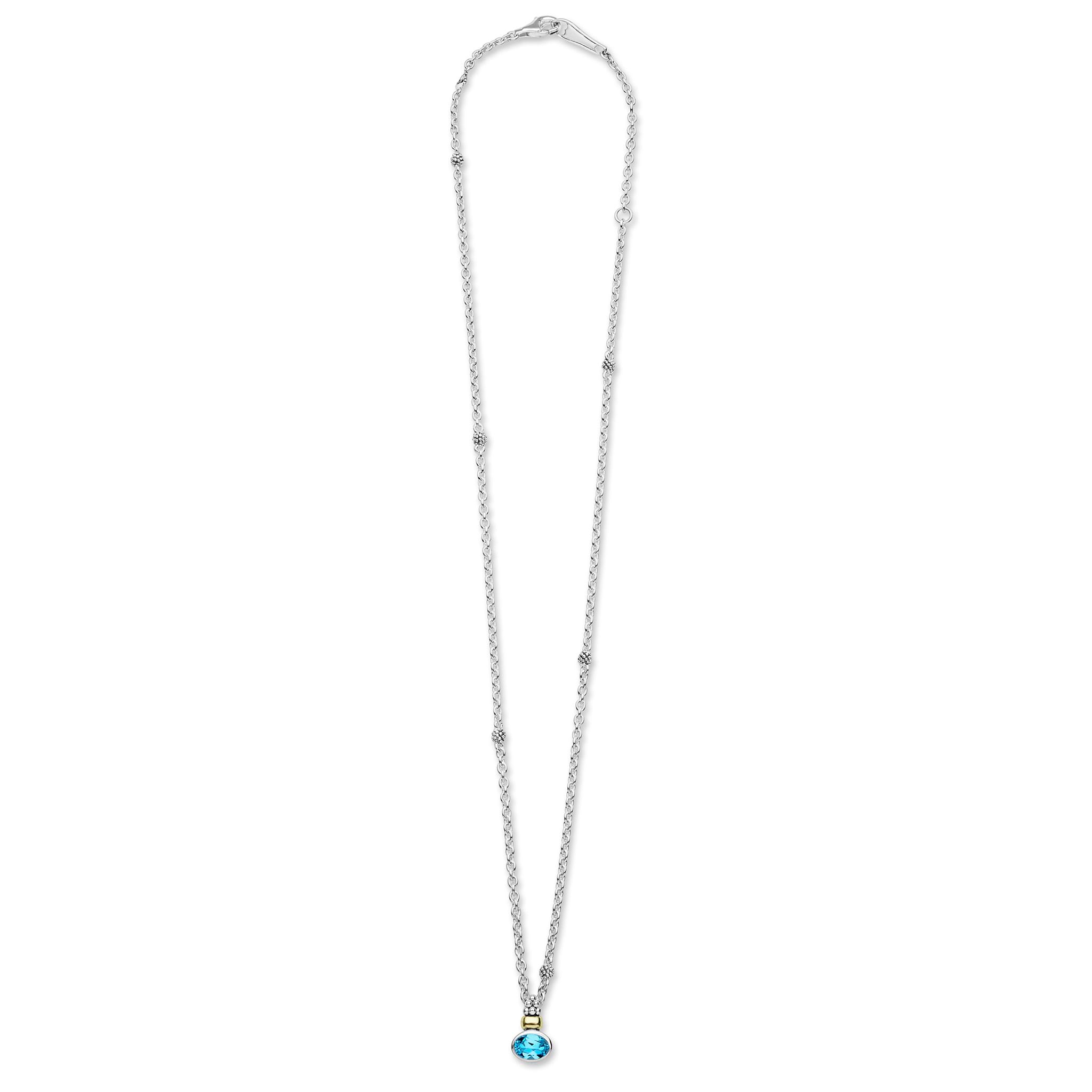 Signature Caviar Two-Tone Swiss Blue Topaz Oval Pendant Necklace features a Y-shape sterling silver chain with bead accents and an oval blue topaz highlighted by 14K gold.