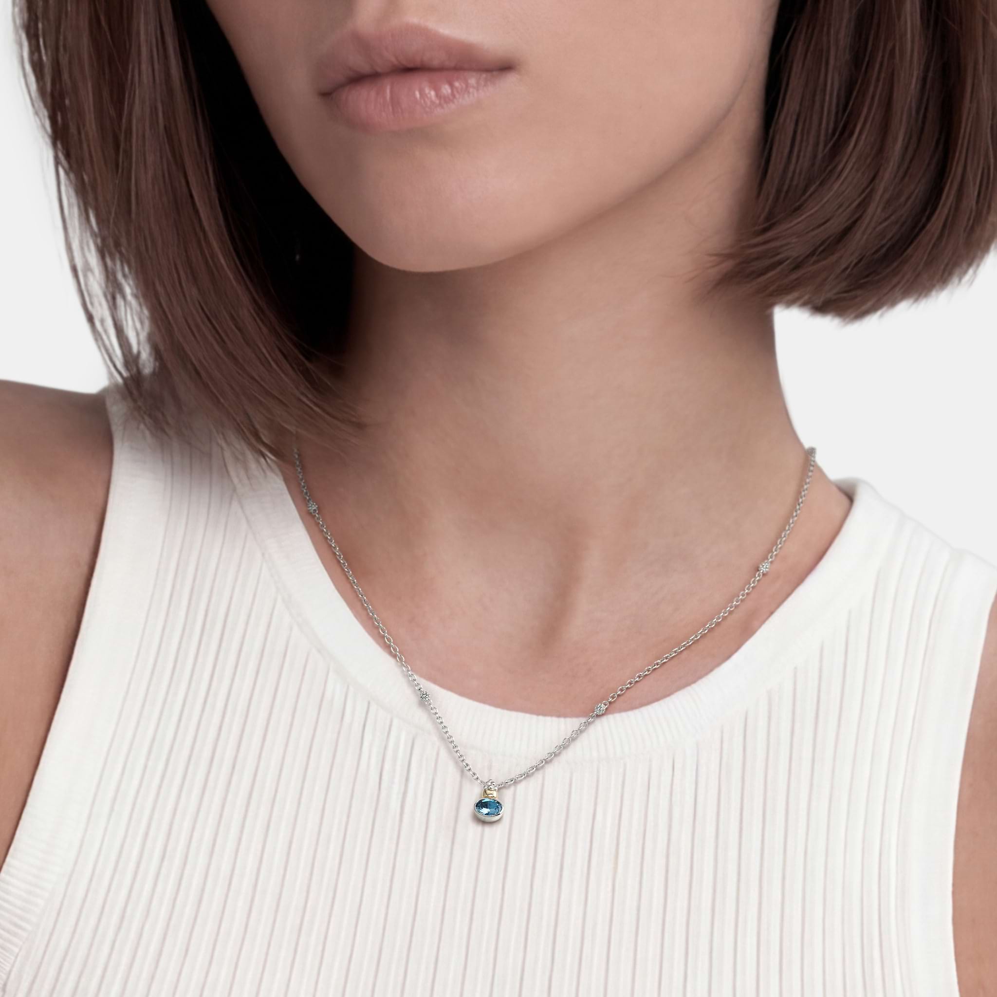 Woman wearing a Two-Tone Swiss Blue Topaz Oval Pendant Necklace