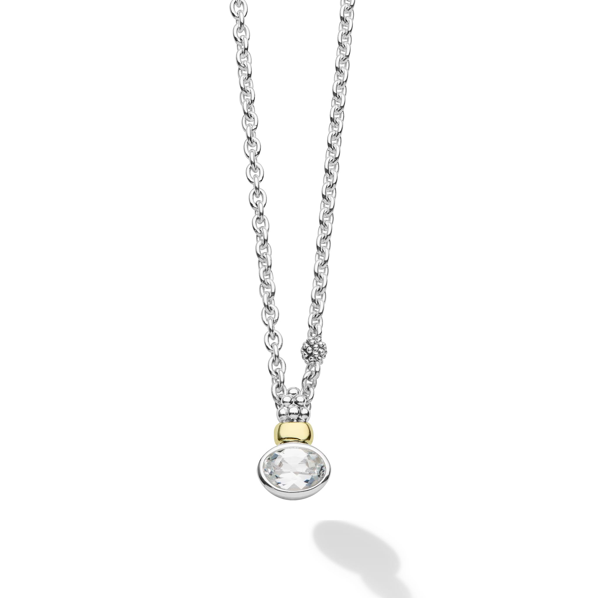 Signature Caviar Two-Tone White Topaz Oval Pendant Necklace with a faceted gemstone, yellow-gold bead, and sterling silver chain, showcasing LAGOS' elegant craftsmanship.