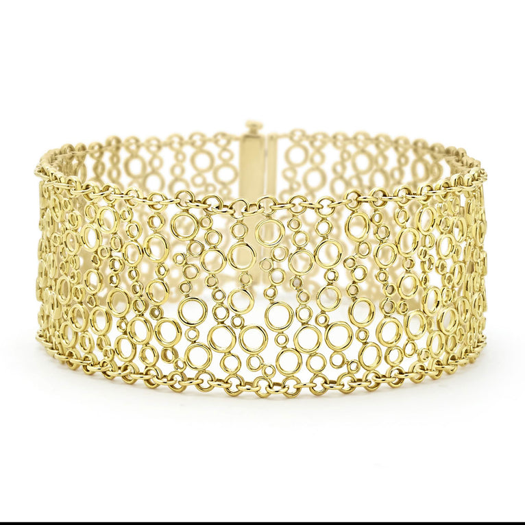 Smooth 18K gold circles form this dramatic cuff bracelet.