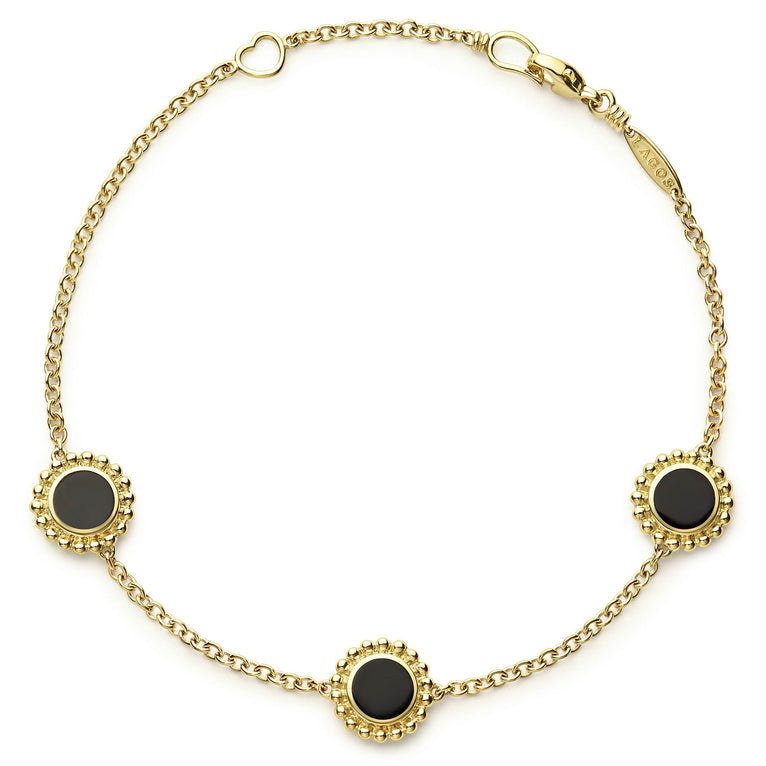 An 18k gold bracelet including three onyx inlay stations with Caviar beaded details.