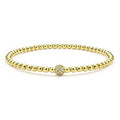 A single pavé diamond sphere on an 18K gold Caviar beaded stretch bracelet.
